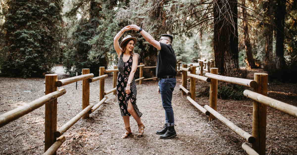 couple dancing on pathway in the woods