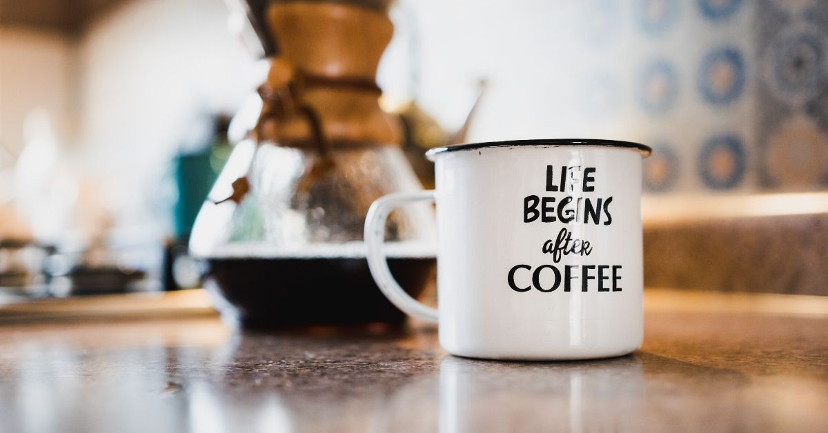 picture of a mug on table which says "life begins after coffee"
