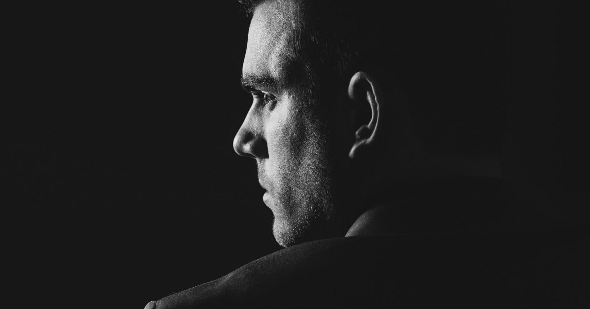 image of a black and white image of a shadowy profile of a man's face