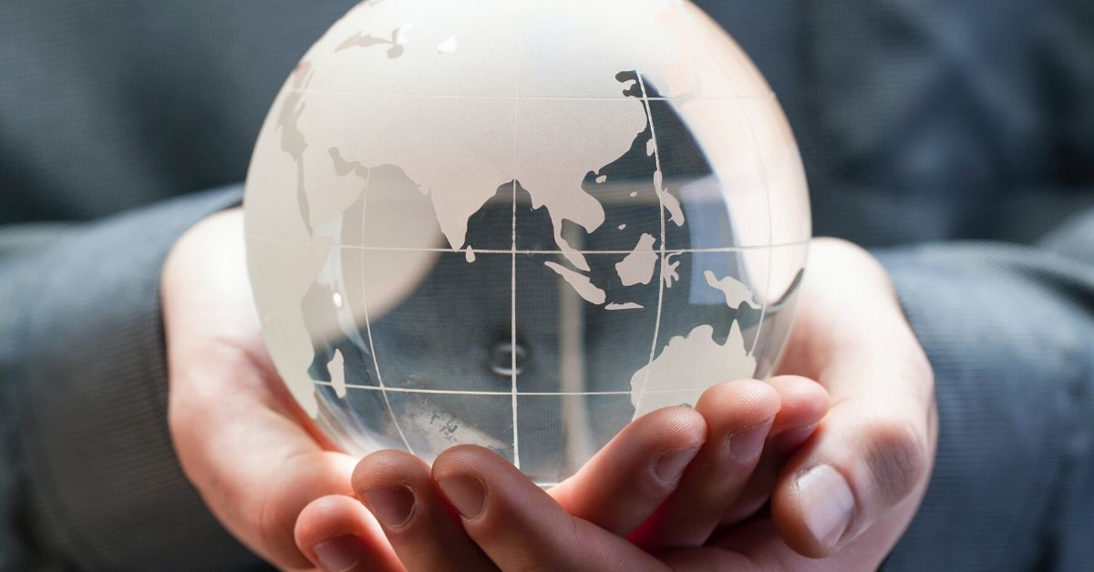 photo of a person holding a glass globe in their hands