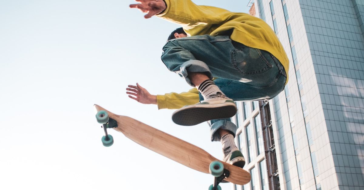 photo of a boy doing a jump on a skateboard