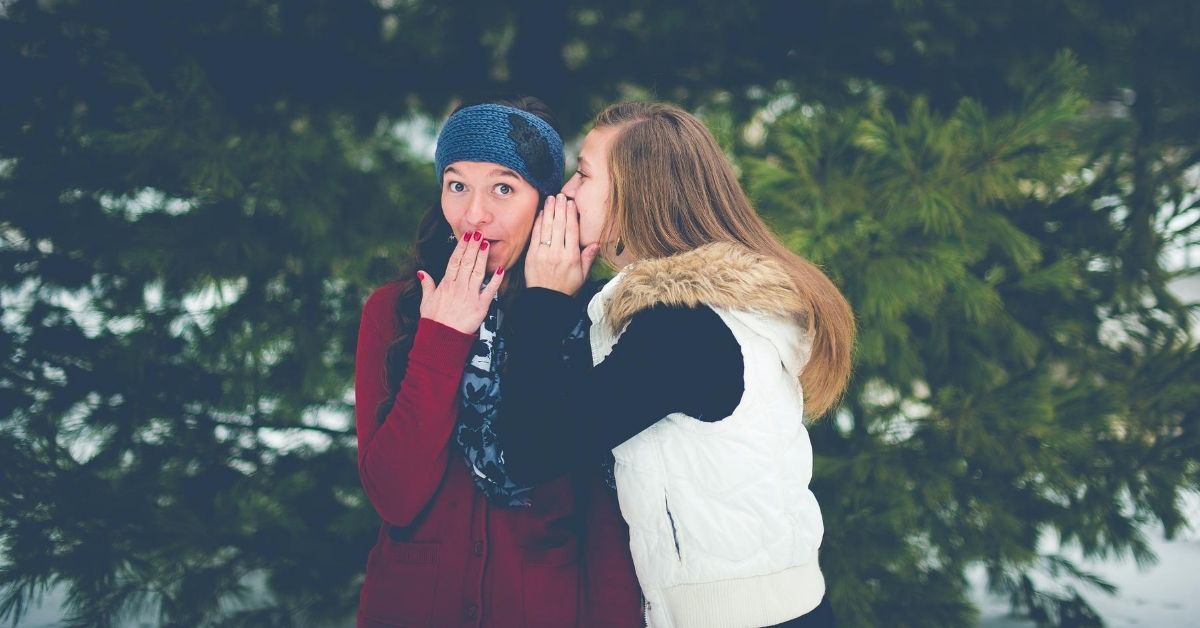 girl whispering to her friend