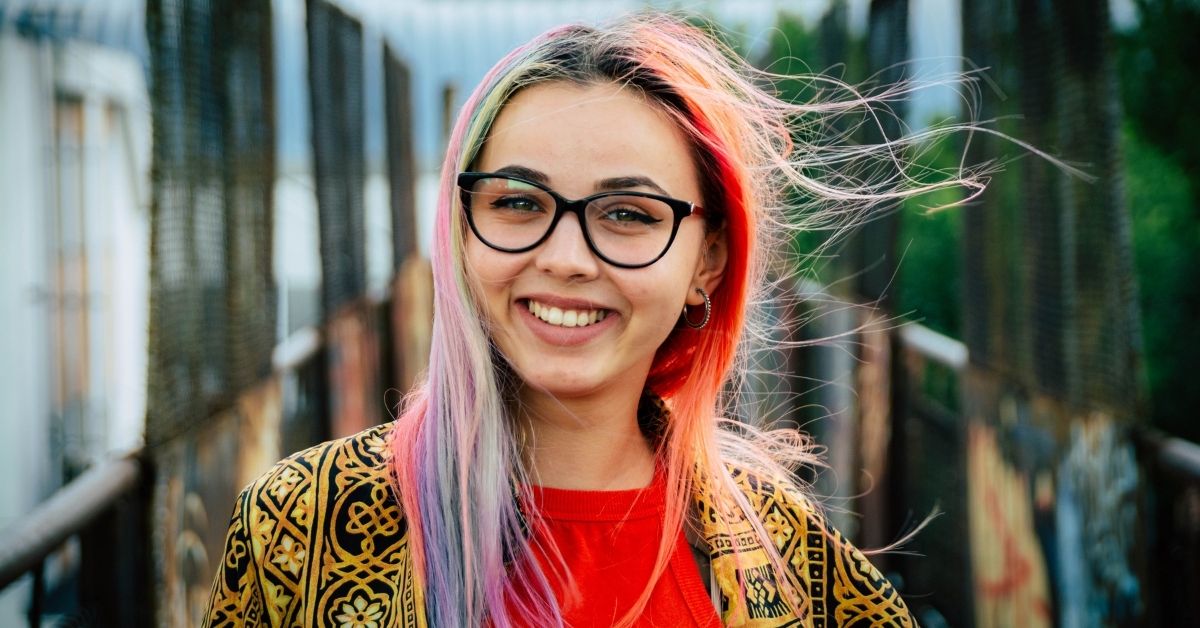 smiling girl with brightly coloured rainbow hair