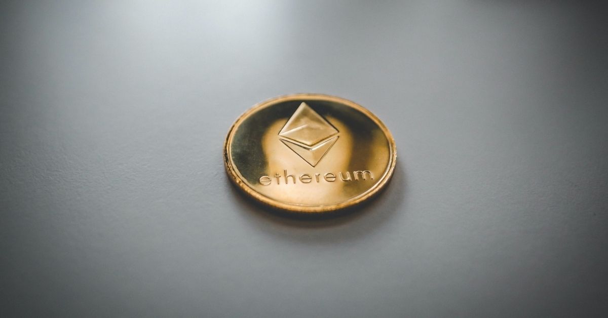 a physical ethereum coin on white surface