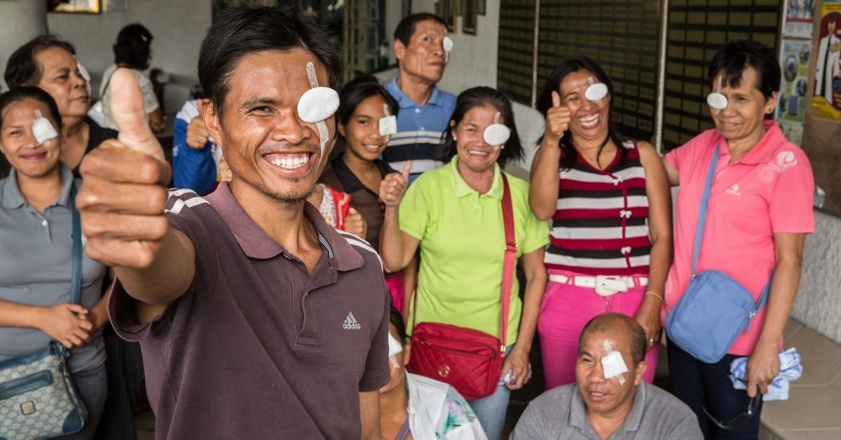 Raul, a farmer from Bacolod in the Philippines, with a group of people who now have restored sight after receiving cataract surgeries