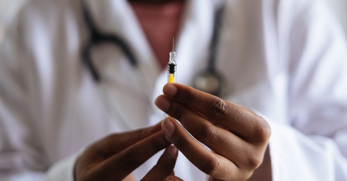 person holding vaccine needle