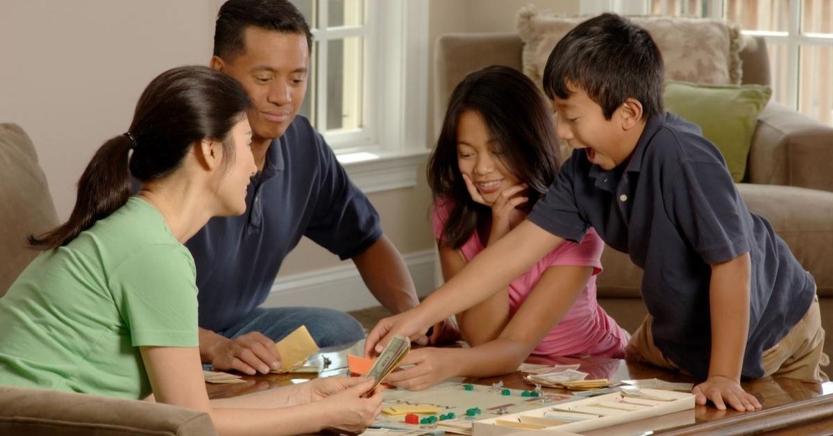 a family playing a game of monopoly