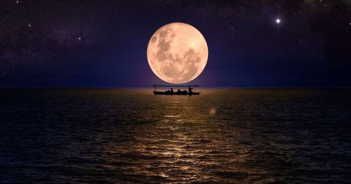 a small boat on the dark seas lit by a full moon