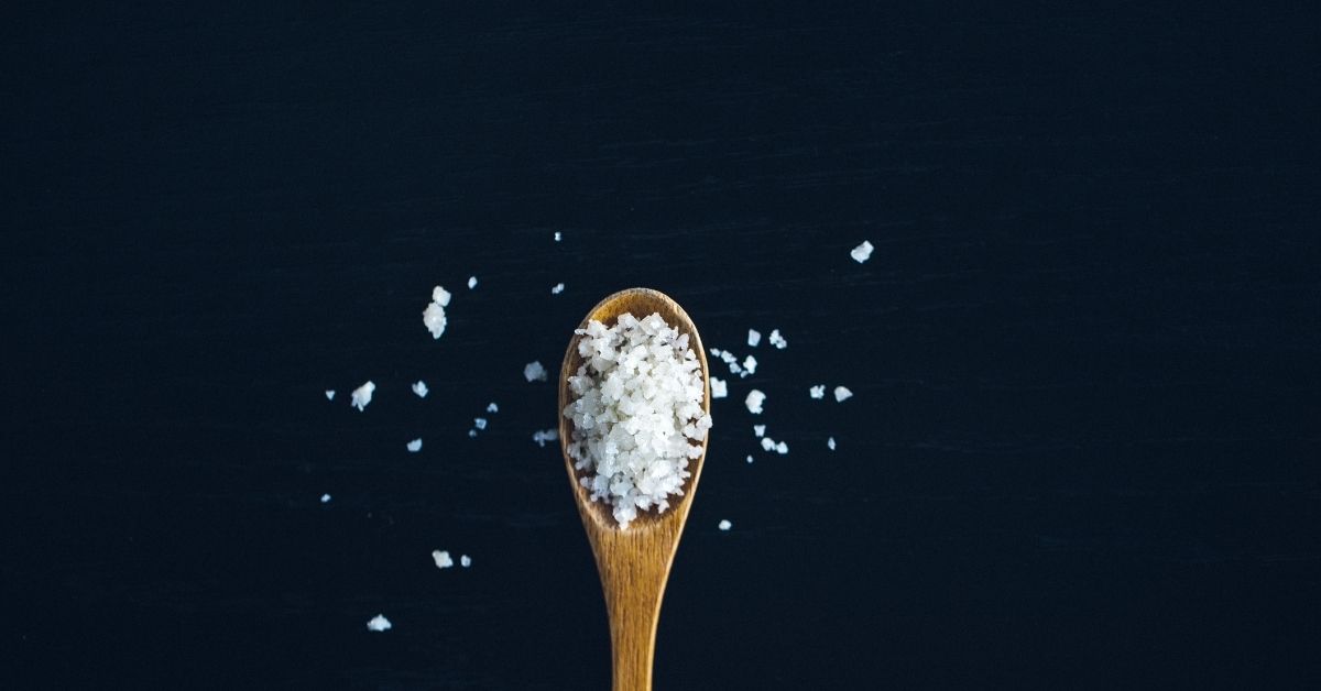 a wooden spoon filled with salt