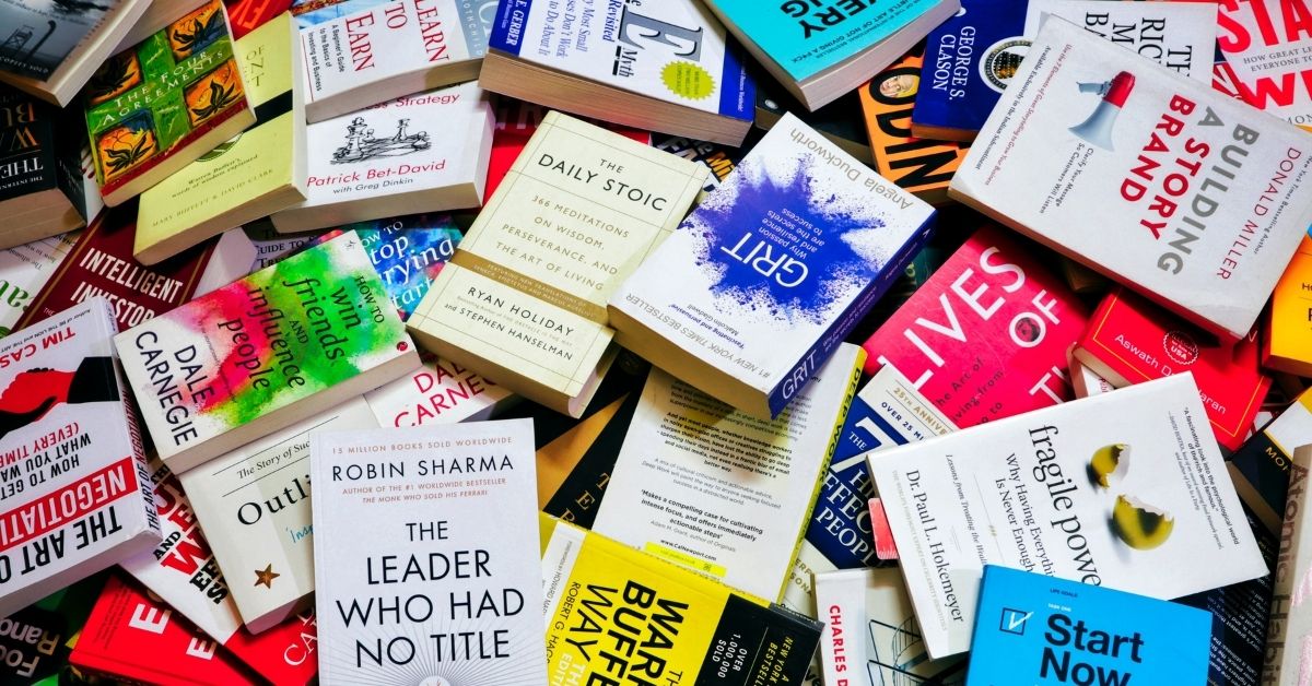 self help books piled on top of each other